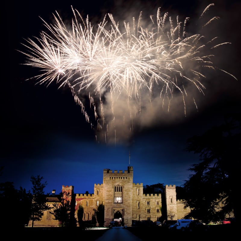 Wedding celebration fireworks exploding over Hampton Court Castle.