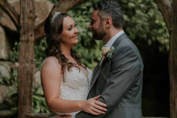 Couple smile together near the waterfall