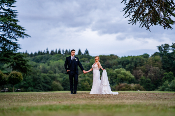 Couple stand together on Hampton Court Castle lawns