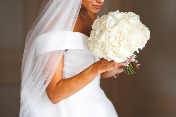 bride holding a white rose bouquet at wedding venue near Hereford